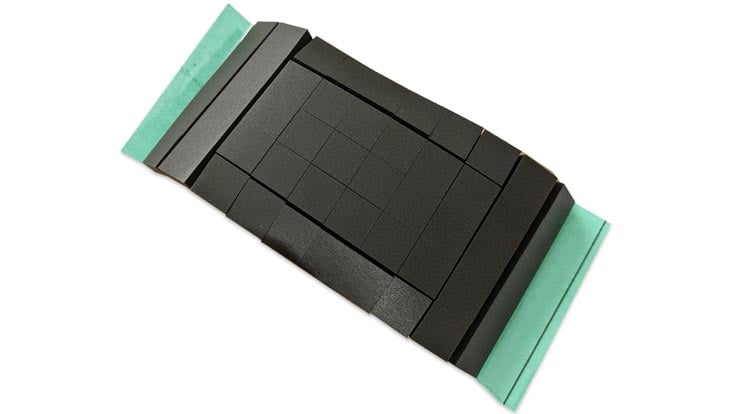 grey kiss-cut adhesive foam squares with green tape backing converted by Boyd